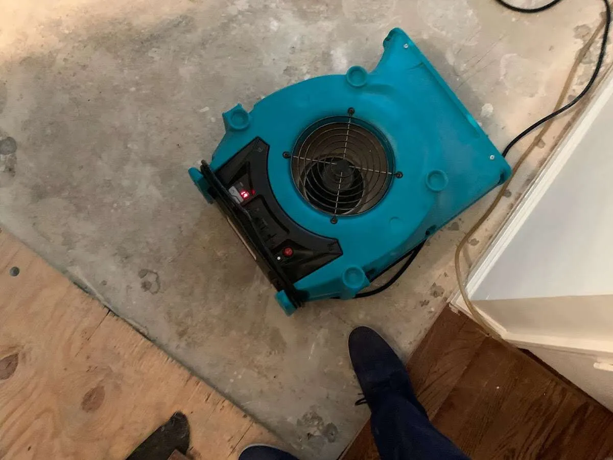 Air mover drying subfloor during Leak Detection & Repair in Kennebunk
